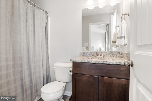 bathroom featuring toilet and vanity