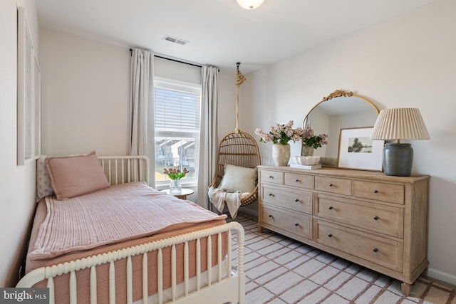 bedroom with light colored carpet and visible vents