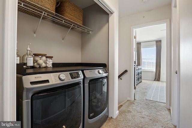 laundry room featuring light carpet, laundry area, independent washer and dryer, and baseboards