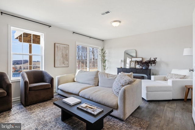 living area with visible vents and dark wood-style flooring