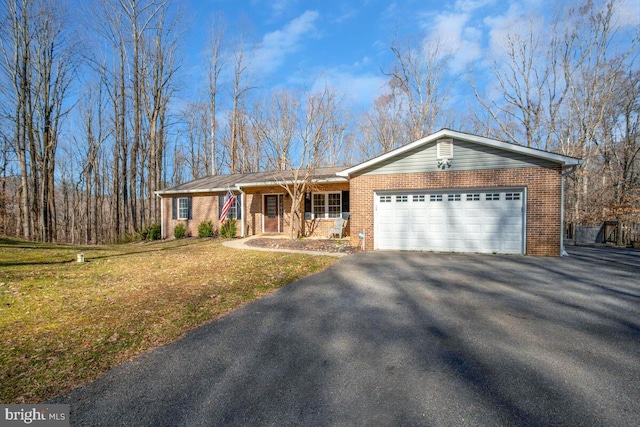 ranch-style home featuring brick siding, driveway, an attached garage, and a front yard