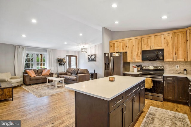 kitchen with light wood-type flooring, lofted ceiling, stainless steel appliances, light countertops, and tasteful backsplash