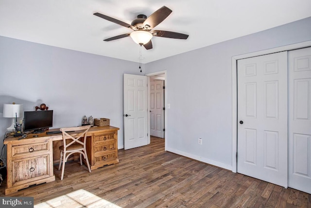 home office featuring baseboards, ceiling fan, and wood finished floors