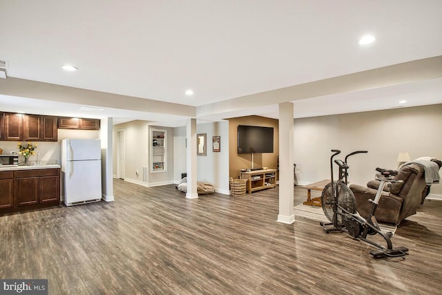 exercise room with recessed lighting, baseboards, and dark wood-style floors