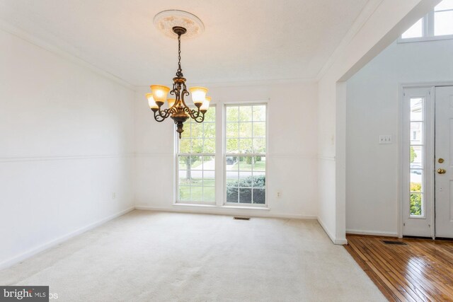foyer featuring an inviting chandelier, baseboards, and a wealth of natural light