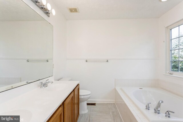 bathroom with a sink, double vanity, toilet, visible vents, and a bath
