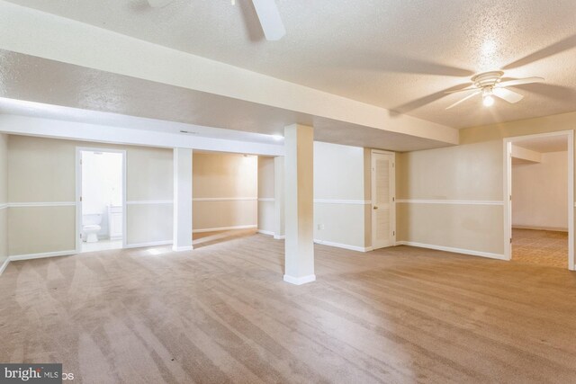 finished basement featuring baseboards, ceiling fan, and carpet