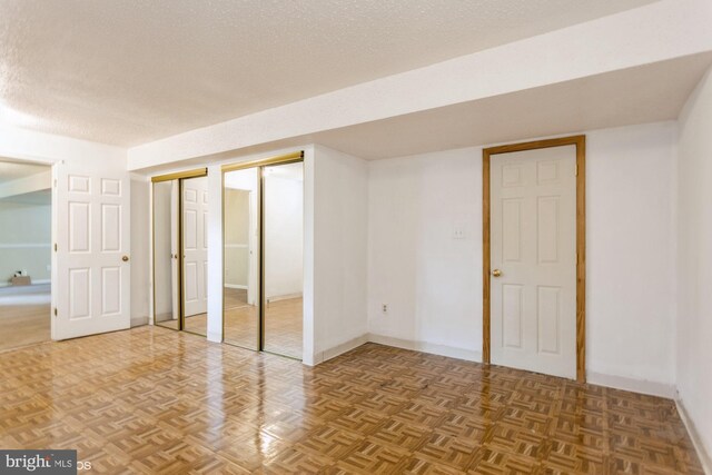 interior space featuring a textured ceiling and baseboards