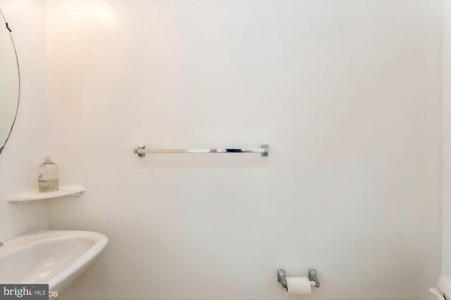 half bathroom featuring a sink