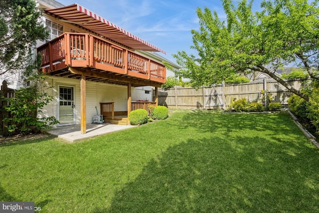 view of yard with a patio area, fence, and a deck