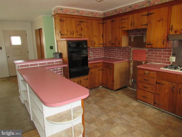 kitchen with brown cabinetry, a peninsula, open shelves, white gas stovetop, and tasteful backsplash