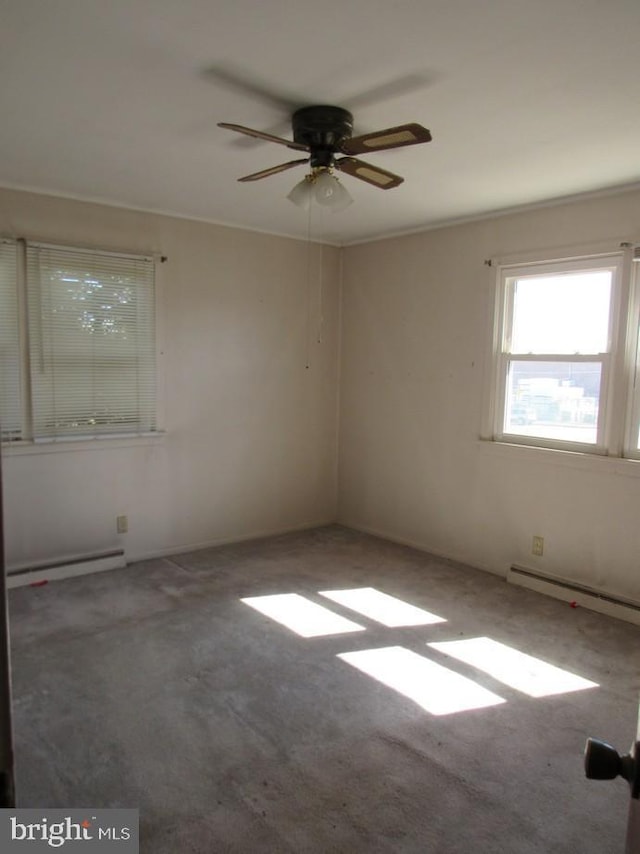 spare room featuring a ceiling fan and a baseboard radiator