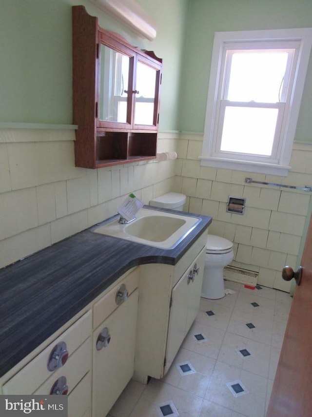 bathroom with vanity, tile patterned floors, toilet, and plenty of natural light