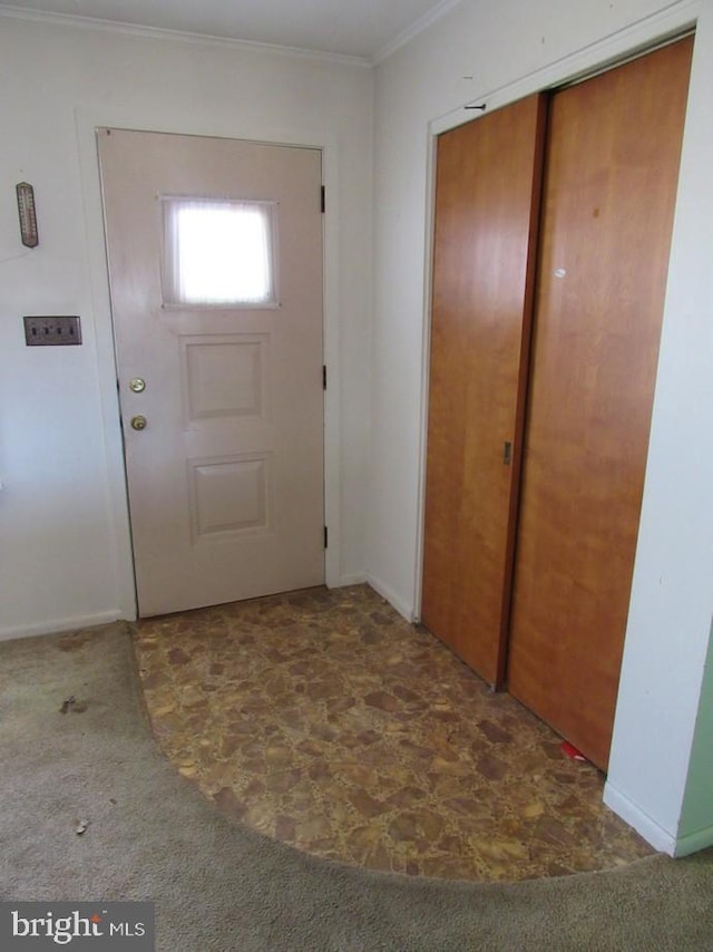 doorway featuring carpet and ornamental molding