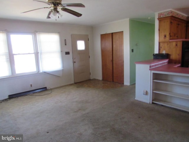 interior space with carpet flooring and a ceiling fan