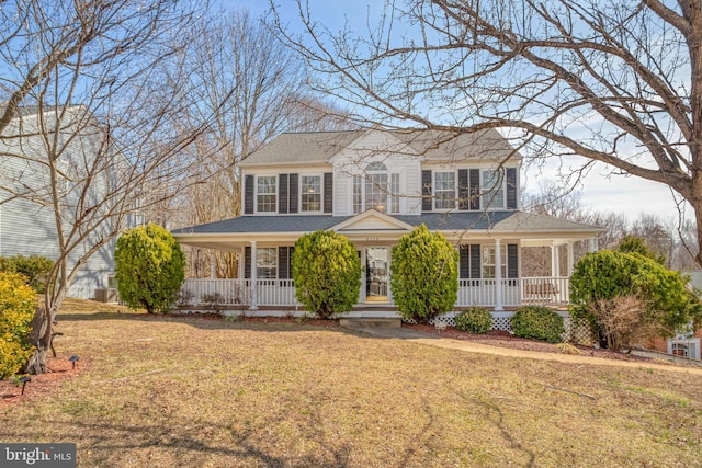 view of front of property with a porch, a front yard, and roof with shingles