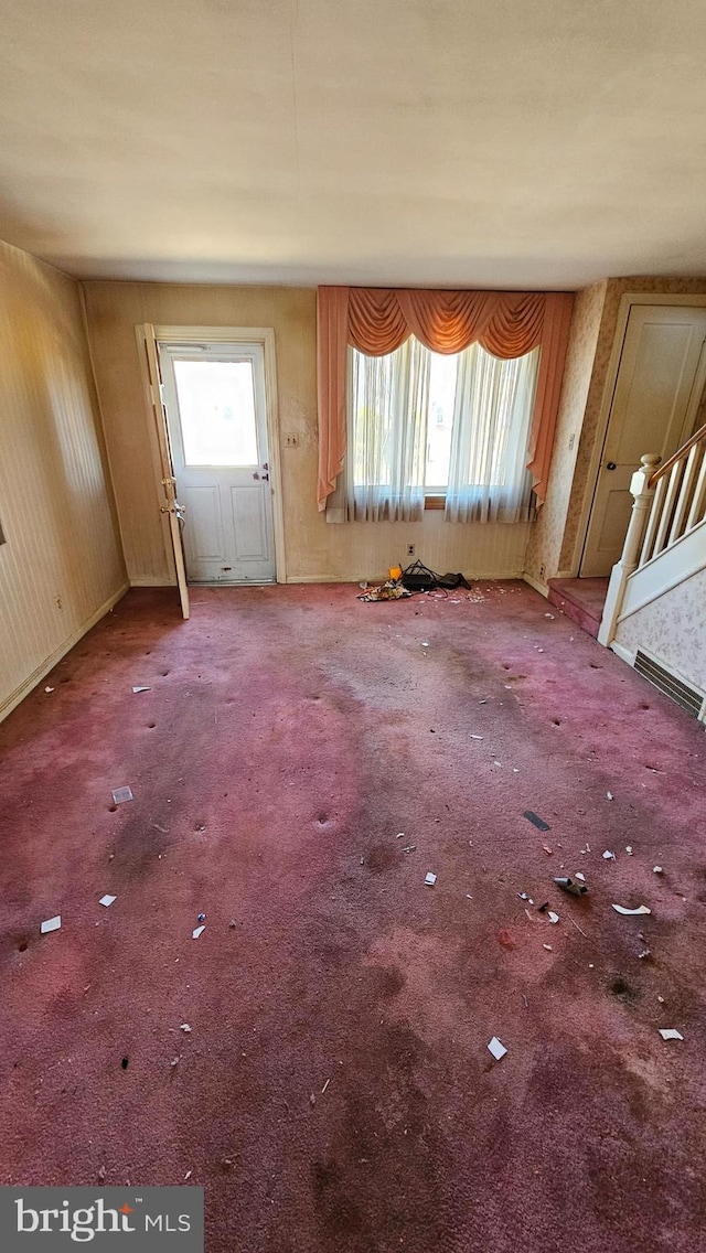 unfurnished living room featuring carpet