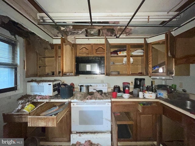 kitchen featuring white appliances, light countertops, and brown cabinets