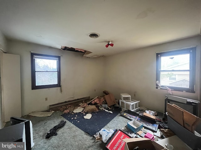 miscellaneous room with a baseboard radiator, carpet, and visible vents