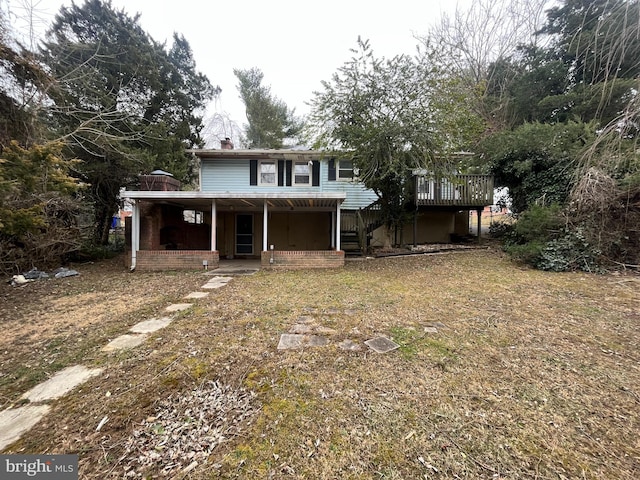 rear view of property with stairs and a chimney