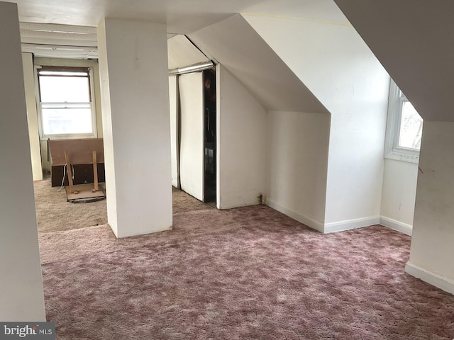 bonus room with vaulted ceiling, carpet flooring, and baseboards