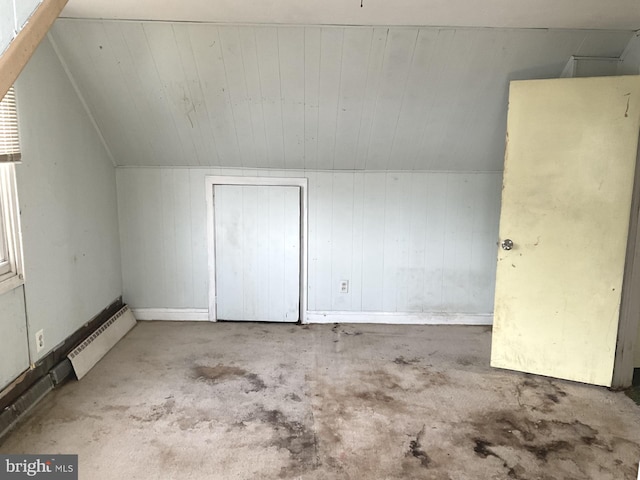 additional living space featuring a baseboard heating unit and lofted ceiling