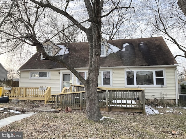 back of property featuring fence and a wooden deck