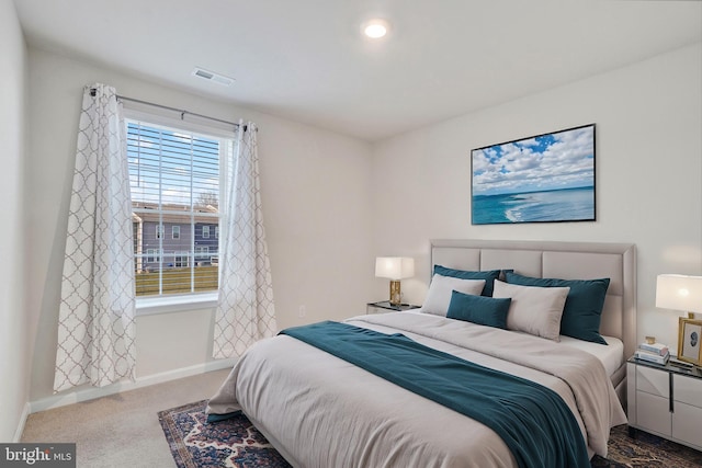 carpeted bedroom with baseboards and visible vents