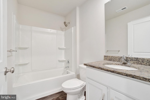 full bath with visible vents, toilet, shower / bathing tub combination, wood finished floors, and vanity