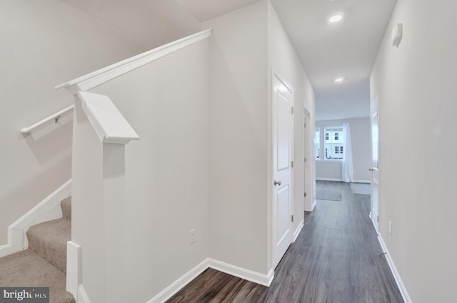 hall with dark wood finished floors, stairway, recessed lighting, and baseboards