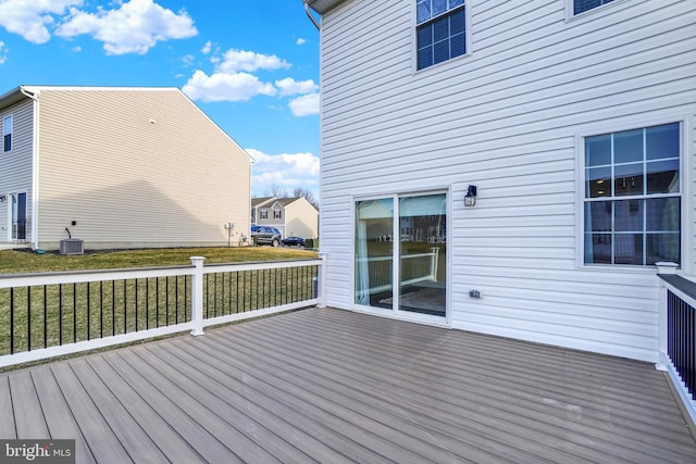 wooden terrace featuring a yard and cooling unit