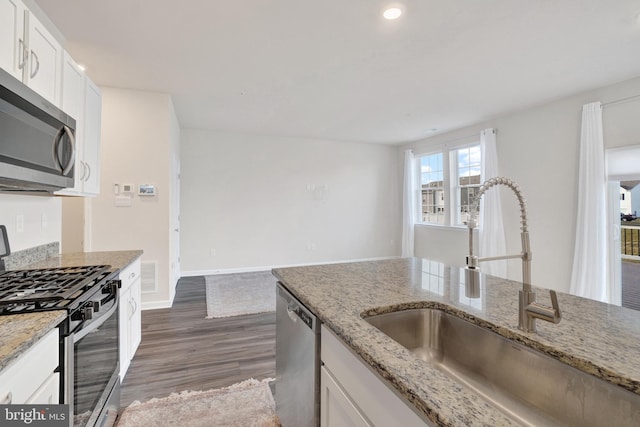 kitchen featuring white cabinets, dark wood-style flooring, appliances with stainless steel finishes, and a sink