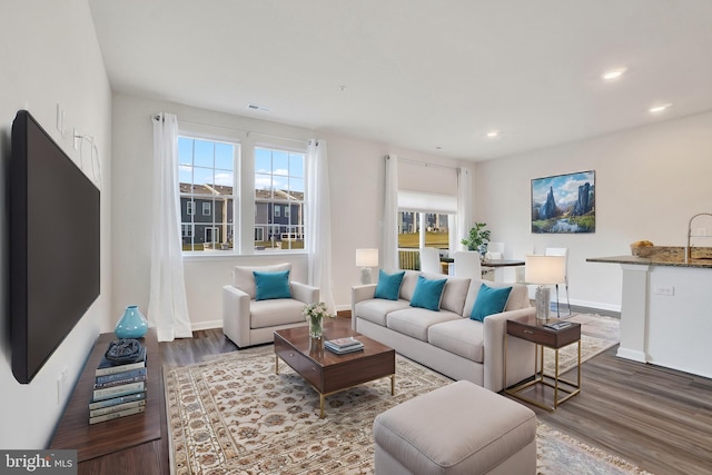 living room with visible vents, recessed lighting, wood finished floors, and baseboards