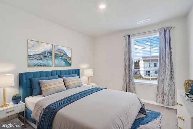 carpeted bedroom with visible vents and baseboards