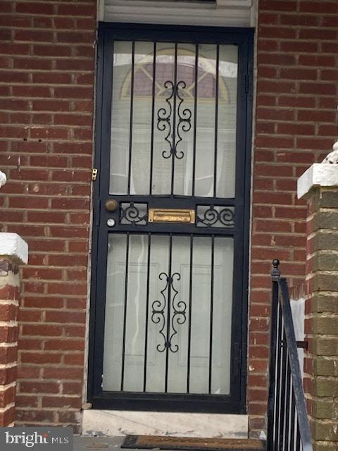 entrance to property with brick siding
