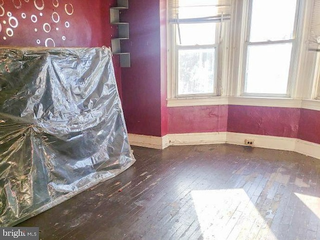 interior space featuring wood finished floors and baseboards