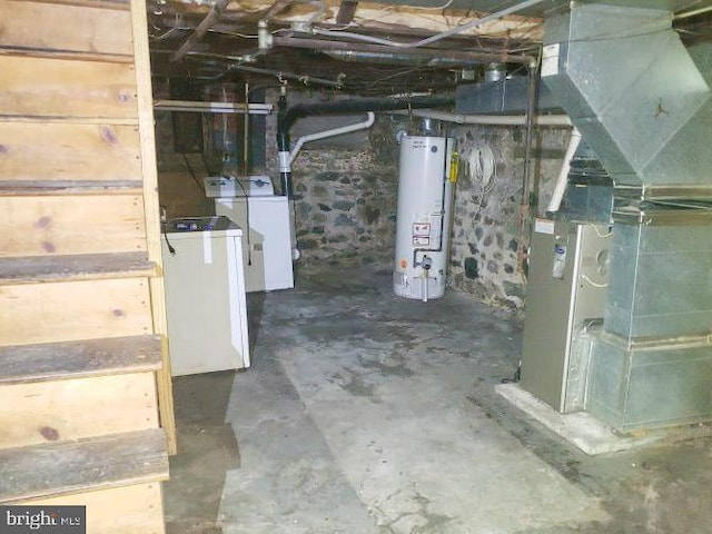 unfinished basement with washer and clothes dryer and gas water heater