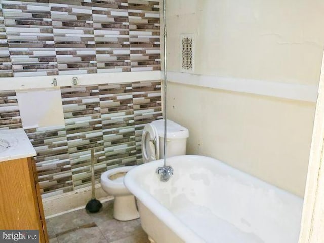 bathroom with tile patterned flooring and a freestanding bath