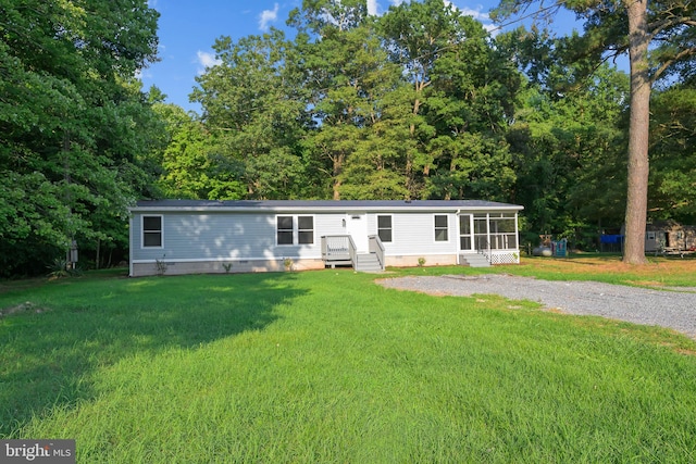 manufactured / mobile home featuring crawl space, a front lawn, and a sunroom