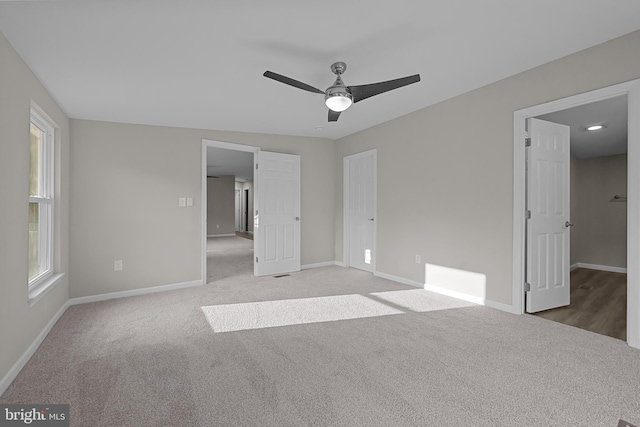 unfurnished bedroom featuring carpet, baseboards, and ceiling fan