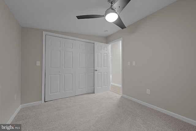 unfurnished bedroom with a closet, baseboards, and carpet floors