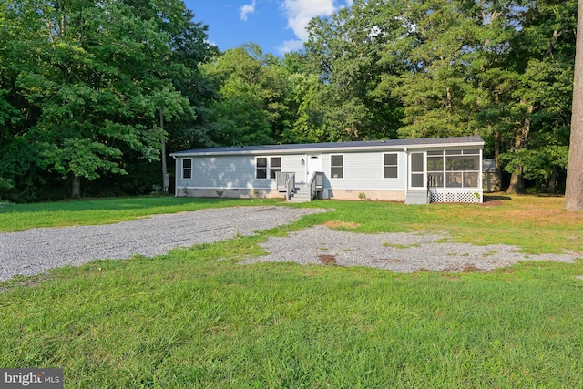 manufactured / mobile home featuring crawl space, a front yard, and a sunroom