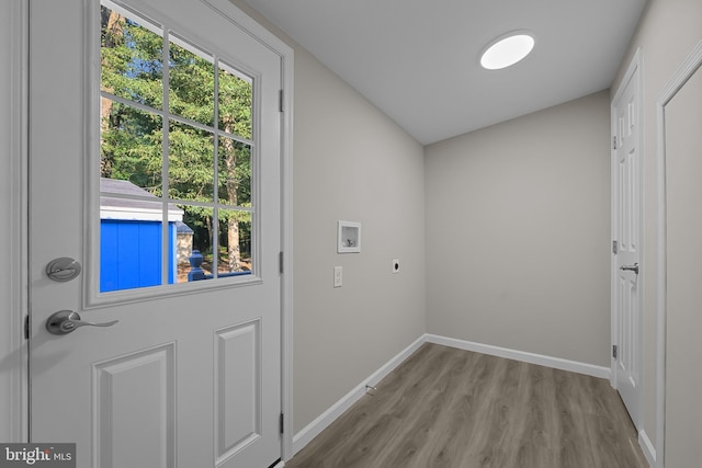 entryway with wood finished floors and baseboards