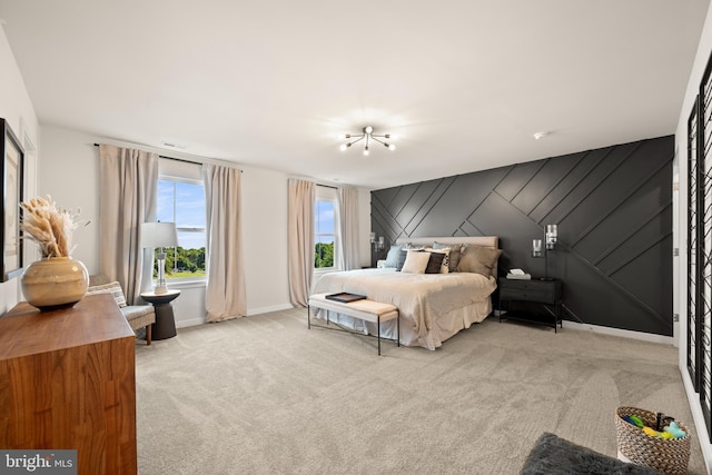 carpeted bedroom featuring visible vents, baseboards, and an accent wall