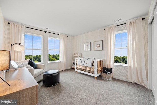 bedroom with wallpapered walls, carpet flooring, and visible vents