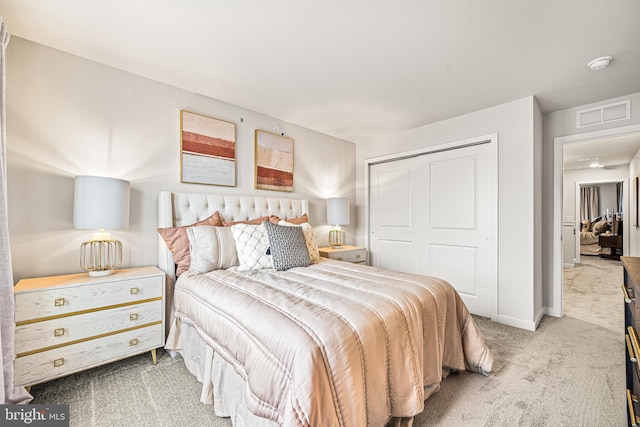 carpeted bedroom with baseboards, visible vents, and a closet