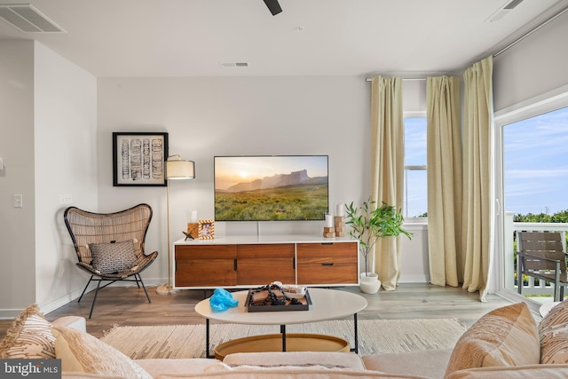 sitting room featuring visible vents, baseboards, and wood finished floors