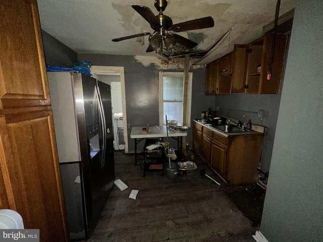 kitchen with refrigerator with ice dispenser, brown cabinets, ceiling fan, and a sink