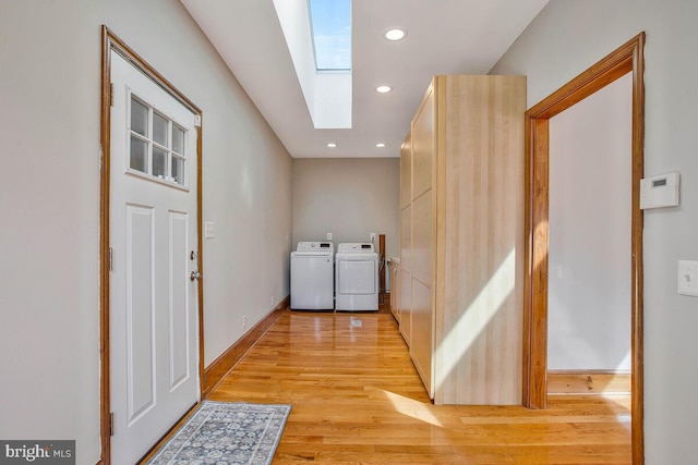 laundry room with washing machine and dryer, laundry area, recessed lighting, a skylight, and light wood-style floors