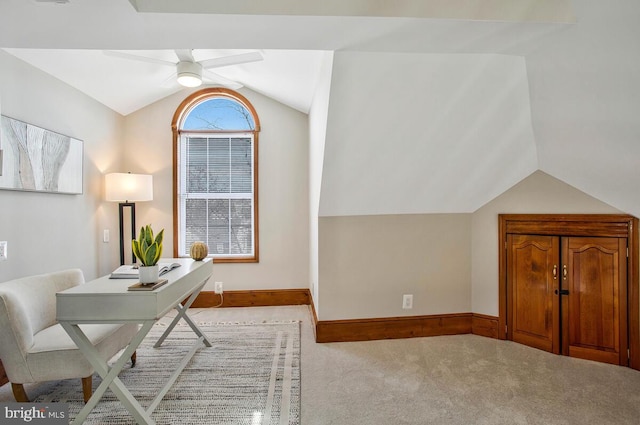 office area featuring carpet flooring, baseboards, ceiling fan, and vaulted ceiling